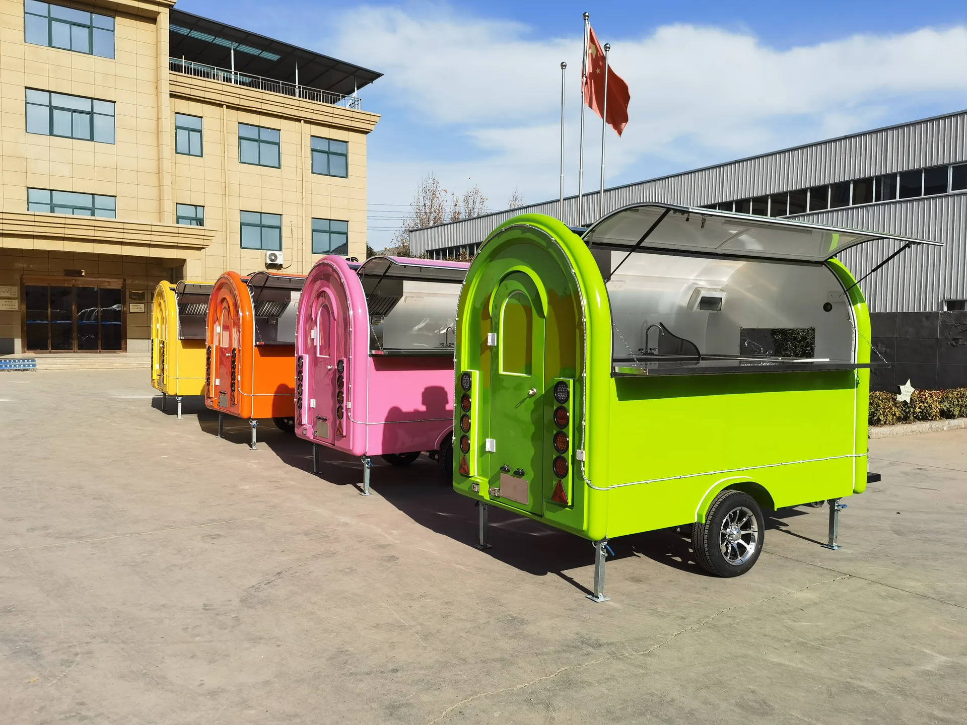 Clean colorful mobile kiosk units outside a factory