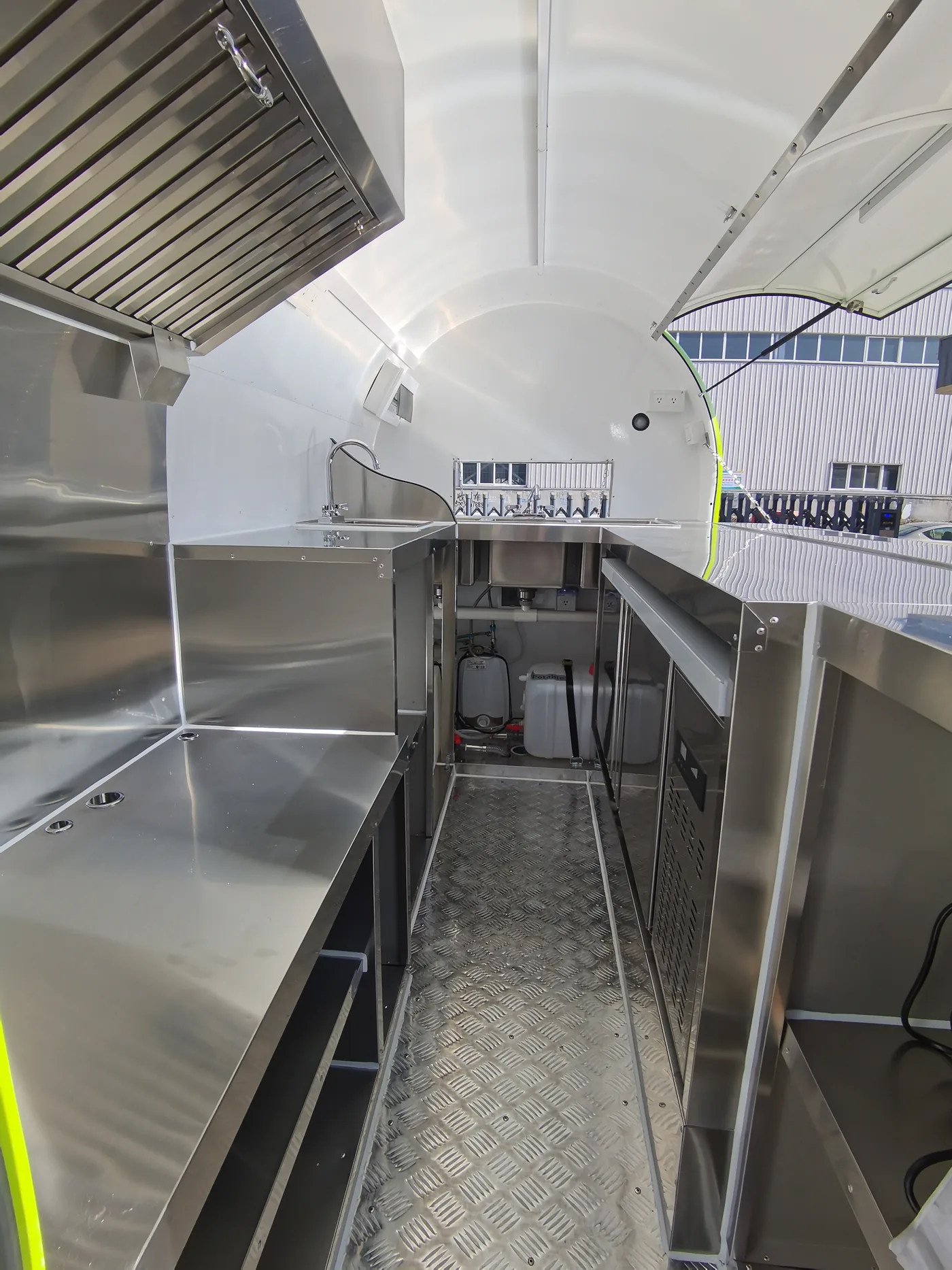 Stainless steel worktop, sink and storage inside a mobile food trailer