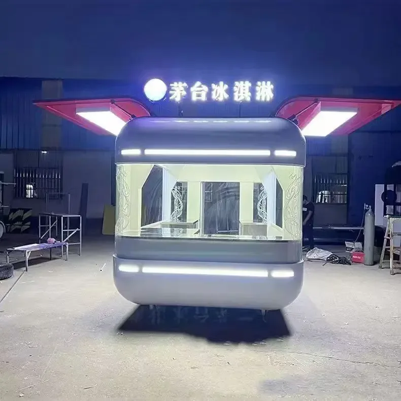 Lighted kiosk at night in a factory yard